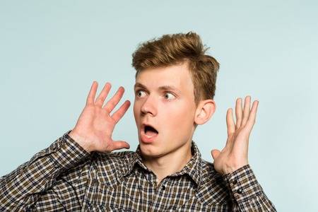105920875-surprised-startled-amazed-astounded-man-gasping-with-astonishment-portrait-of-a-young-guy-on-light-b